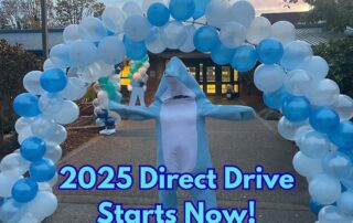 2025 Direct Drive Starts Now! over phot of Lu the dolpin in front of a balloon arch.